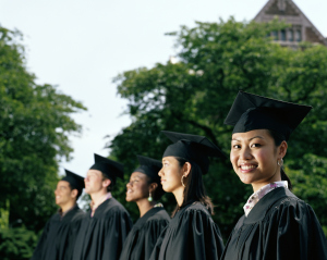 Row of graduates, focus on female graduate smiling